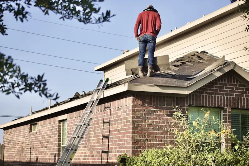 Professional roofer working on a residential roof in Hutchinson